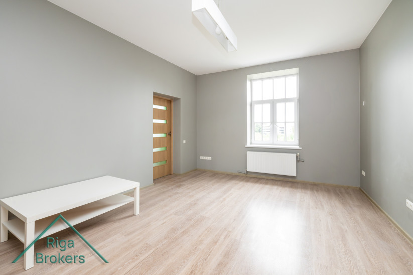 Bright room with a window and furniture.