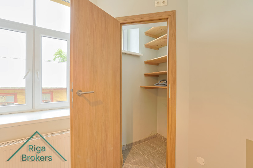 Small room with shelves and a window.
