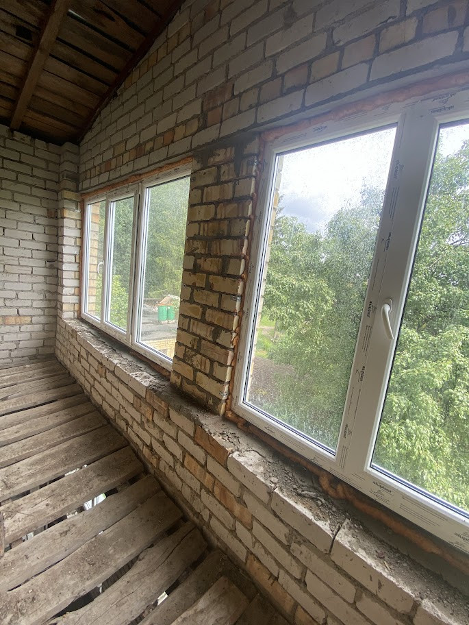 Large windows in a brick-walled room.