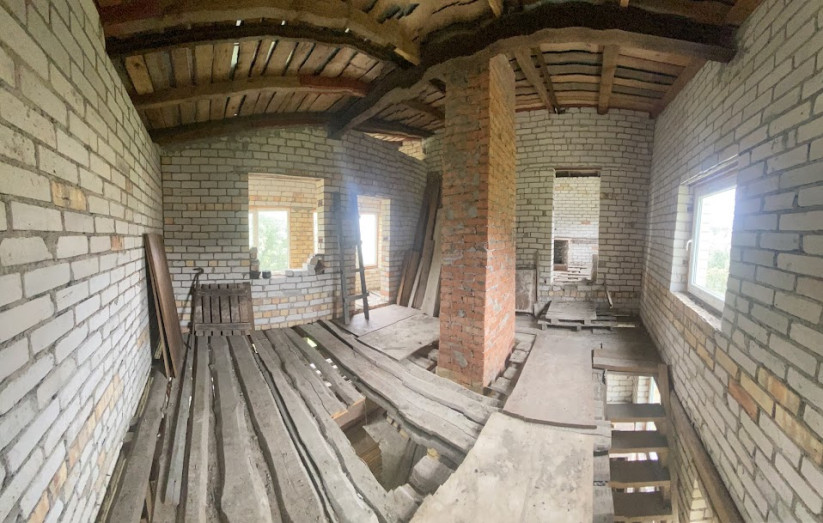  Unfinished attic with wooden floor.