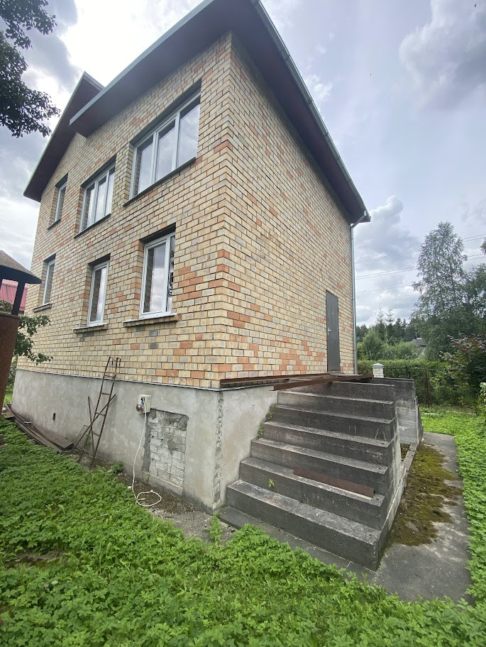 Brick house facade with green lawn