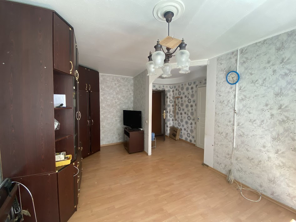 Living room with dark furniture and decorative panels.