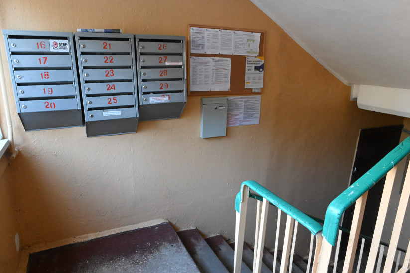 Mailboxes and a notice board in the stairwell