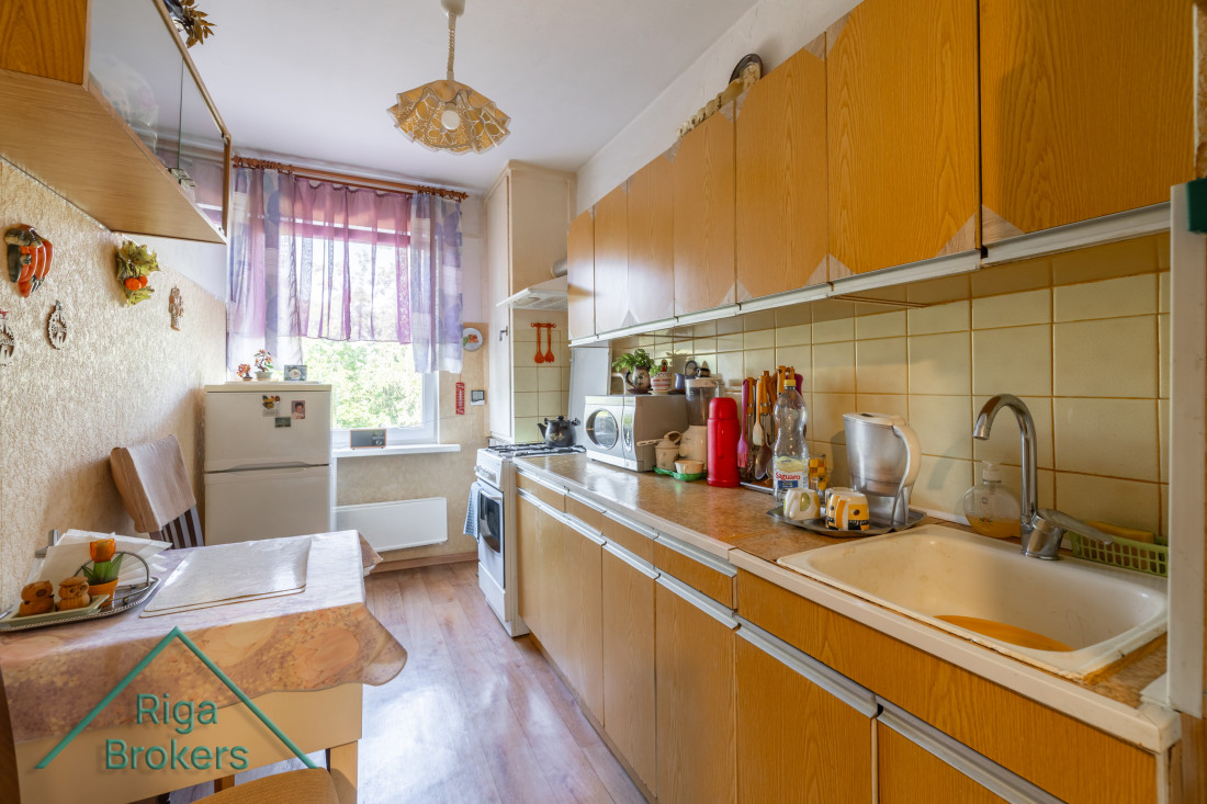 Kitchen view with a window and cabinets.