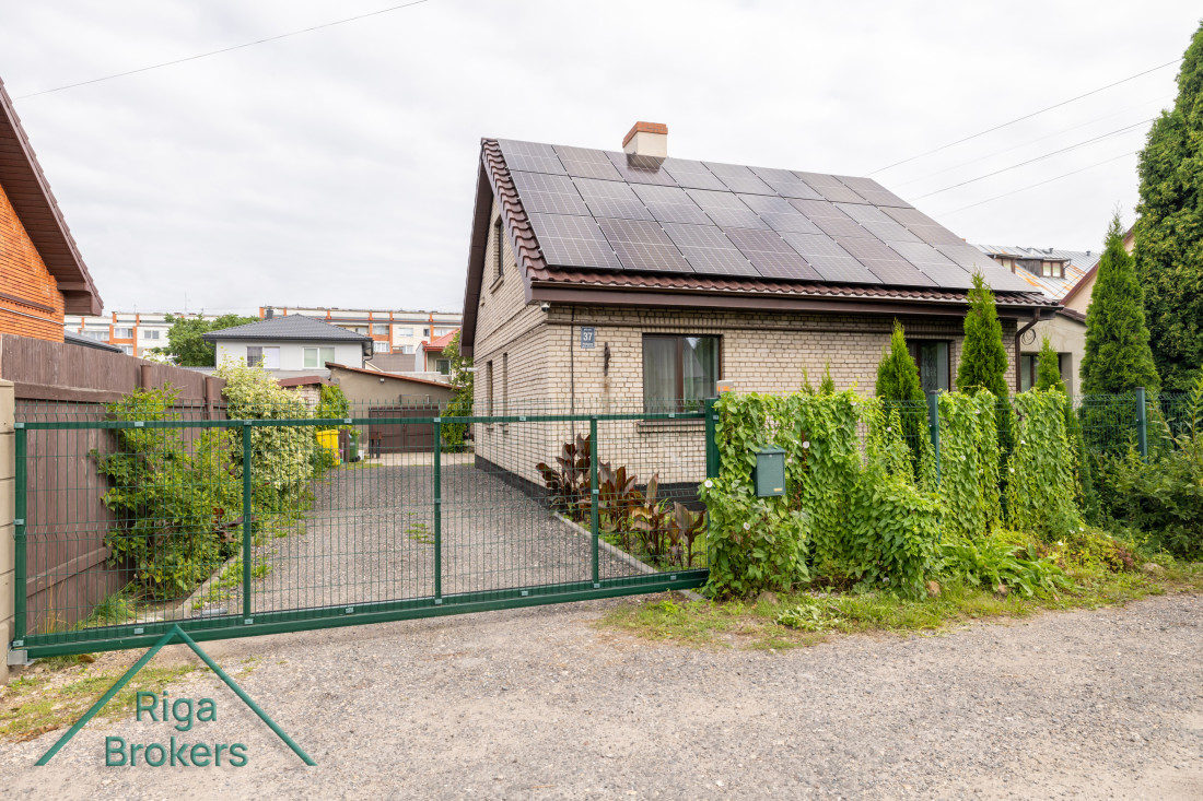 Front gate leading to brick house.