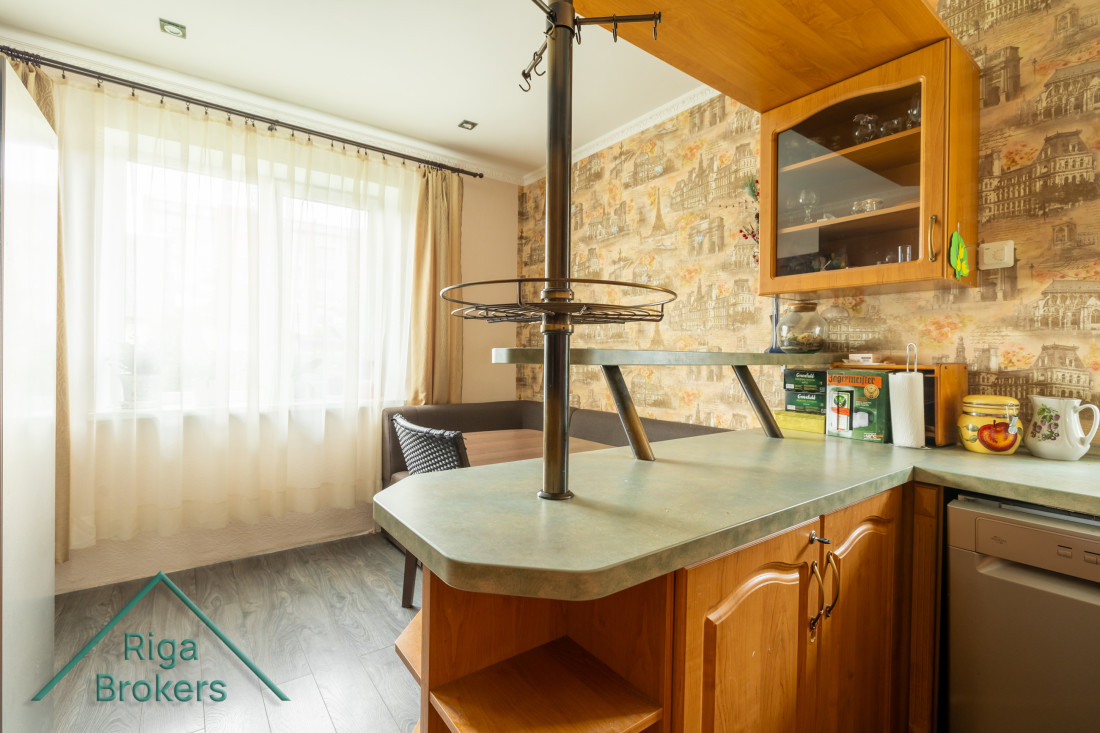 Kitchen area with windows and curtains.