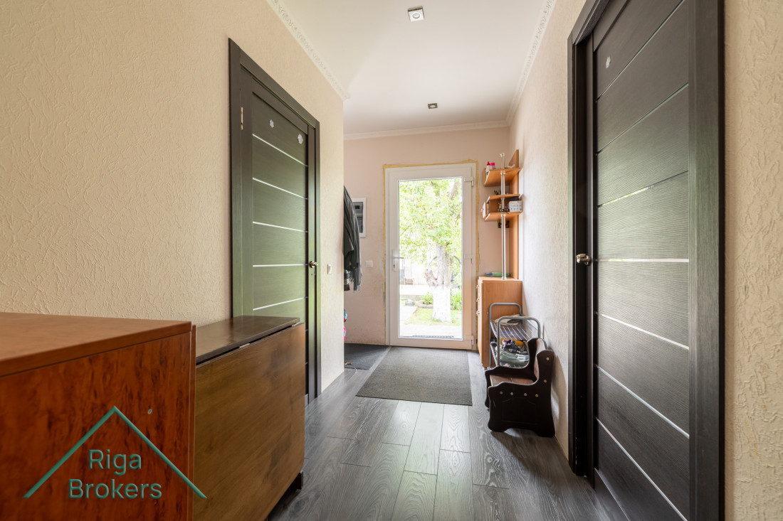  Hallway with dark doors and light wall finish.
