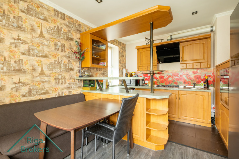 Kitchen with wooden cabinets and table.