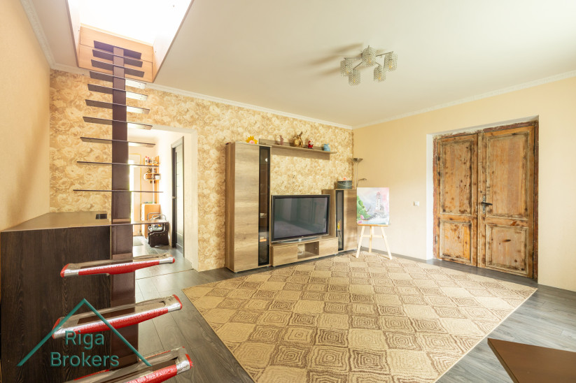 Living room with stairs to the attic.