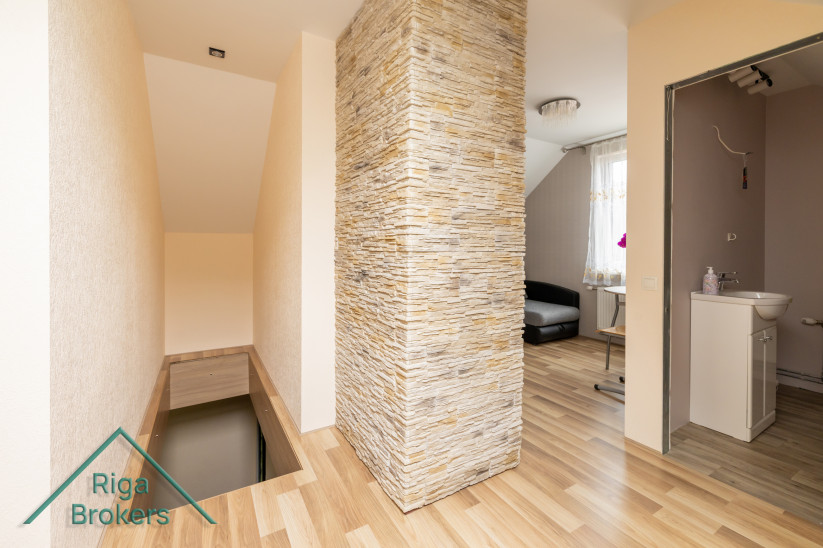 Staircase entrance with stone accent wall.