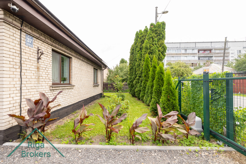 Side view of house with green yard.