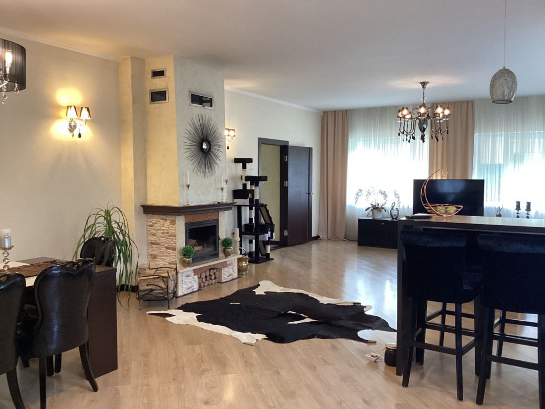 Spacious living room with a fireplace and dining area.