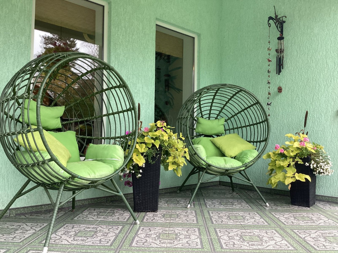  Green chairs and plants on terrace.