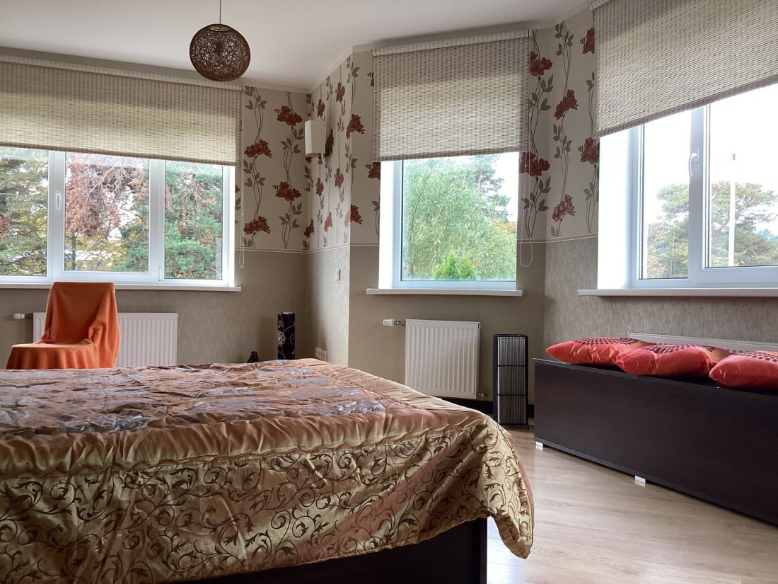 Bedroom with large windows and view.