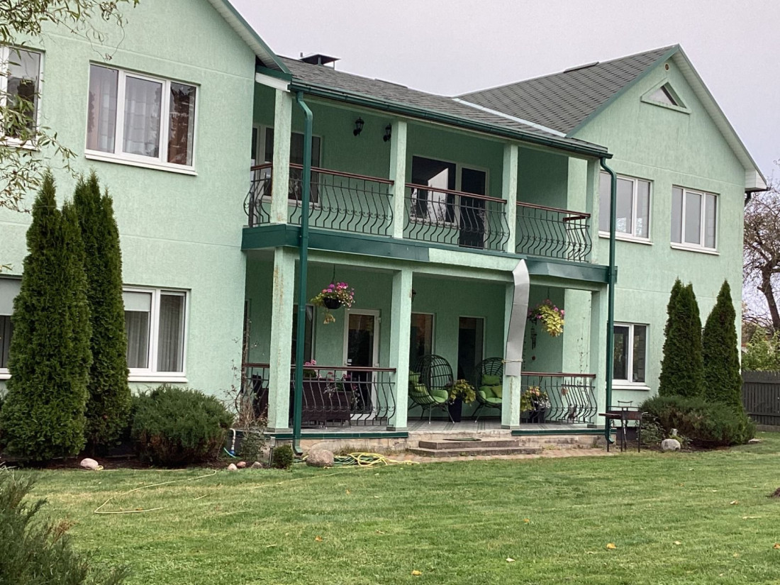 Cozy green house with balconies.