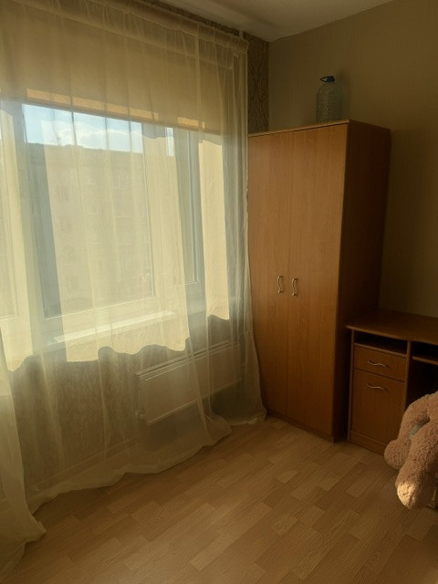 Bedroom with wardrobe and curtains.