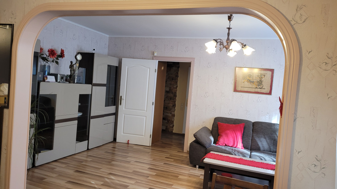 Spacious living room with modern furniture and built-in archway.