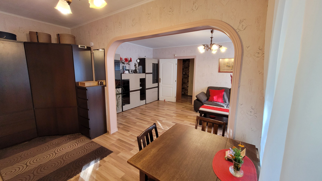 Dining area with a table and chairs in a bright room.