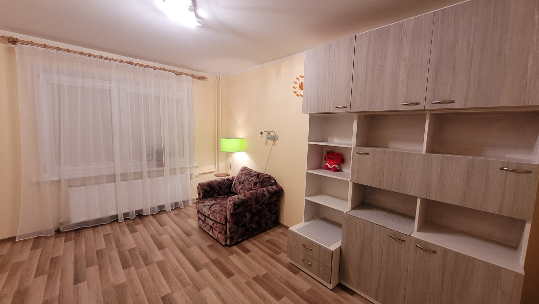 Room with shelf and armchair.