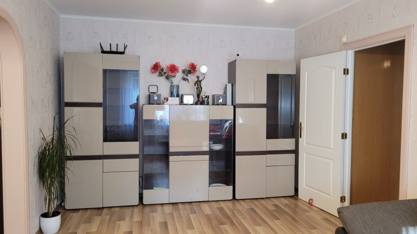Living room with cabinets and flowers.
