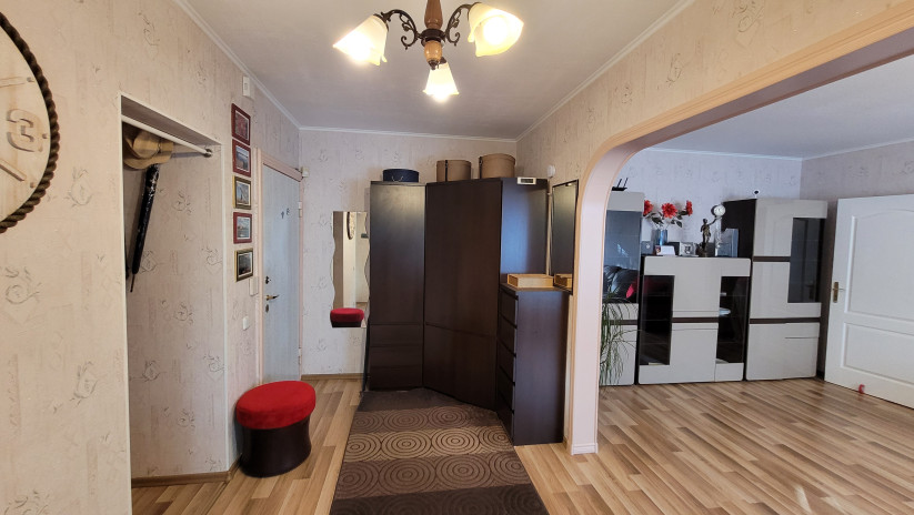 Hallway with built-in wardrobes and a wall mirror.