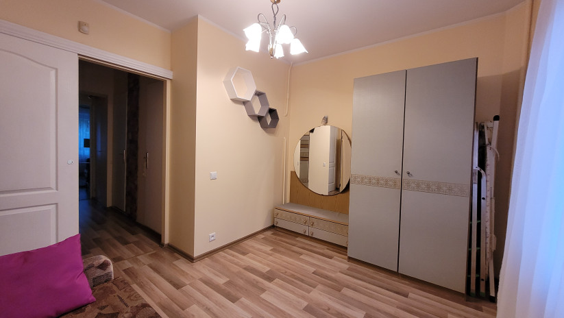 Bedroom with wardrobe and mirror.