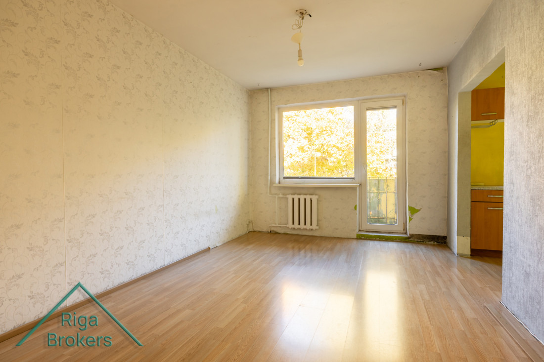 Empty room with light wallpapered walls.