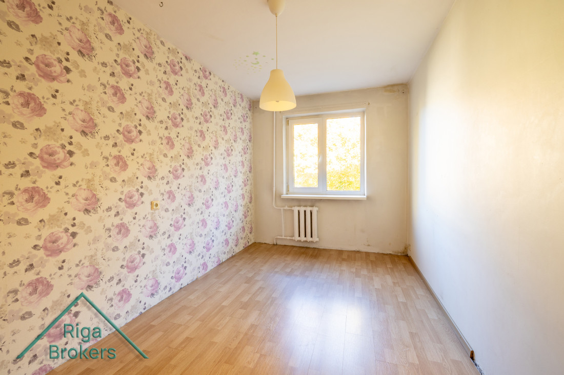 Room with floral wallpaper and window