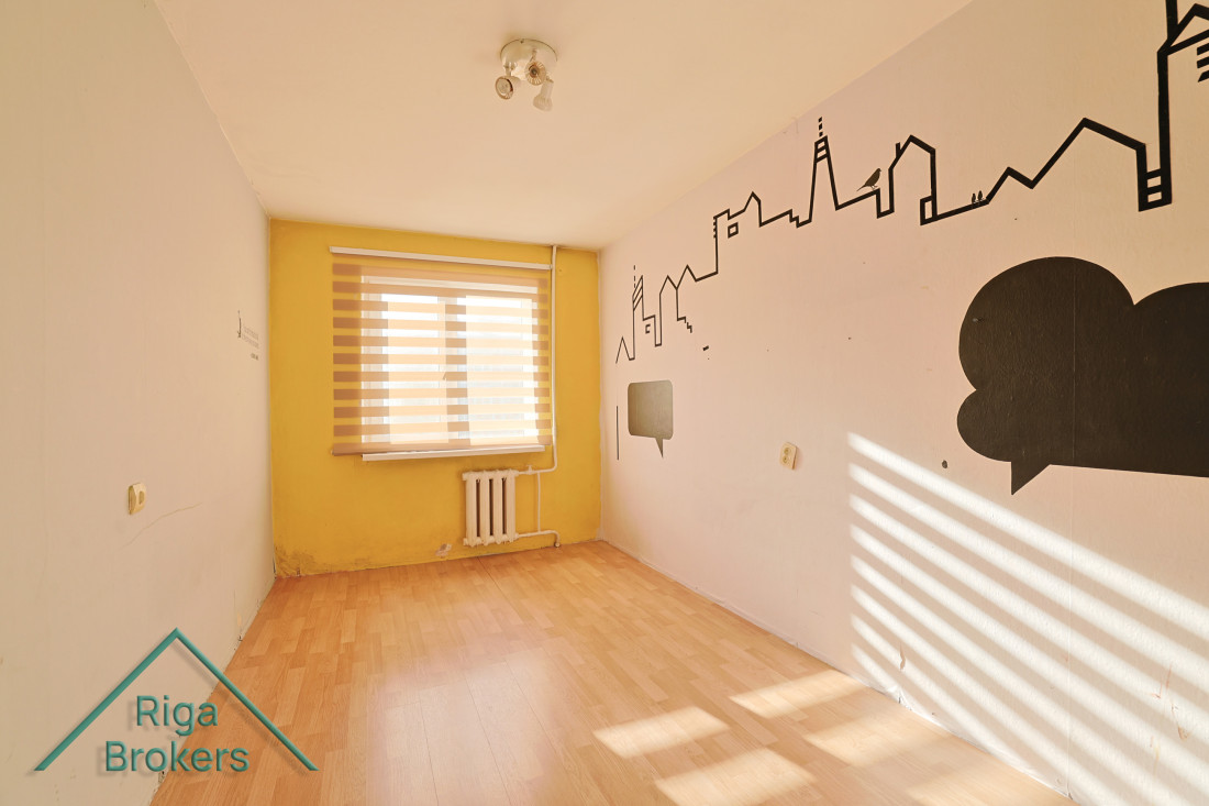 Room with cityscape wall illustration.