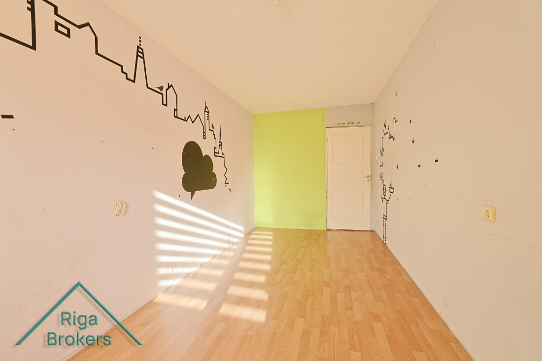 Empty room with wall drawing and green accent.