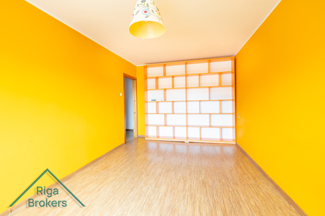 Room with shelves and orange walls.