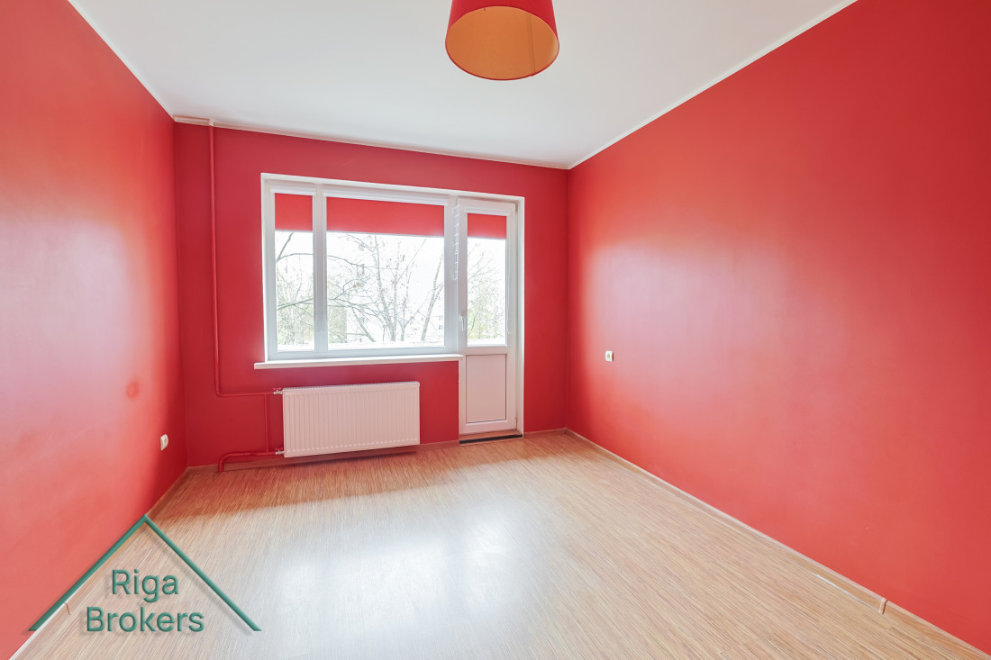 Room with red walls and window.