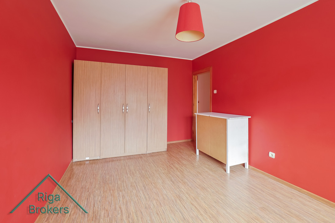 Red room with wardrobes and lamp.