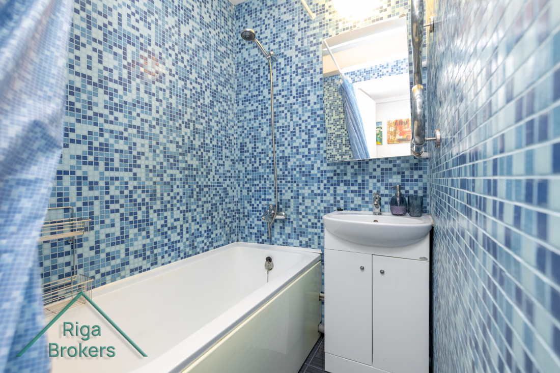 Bathroom with blue tiled finish.