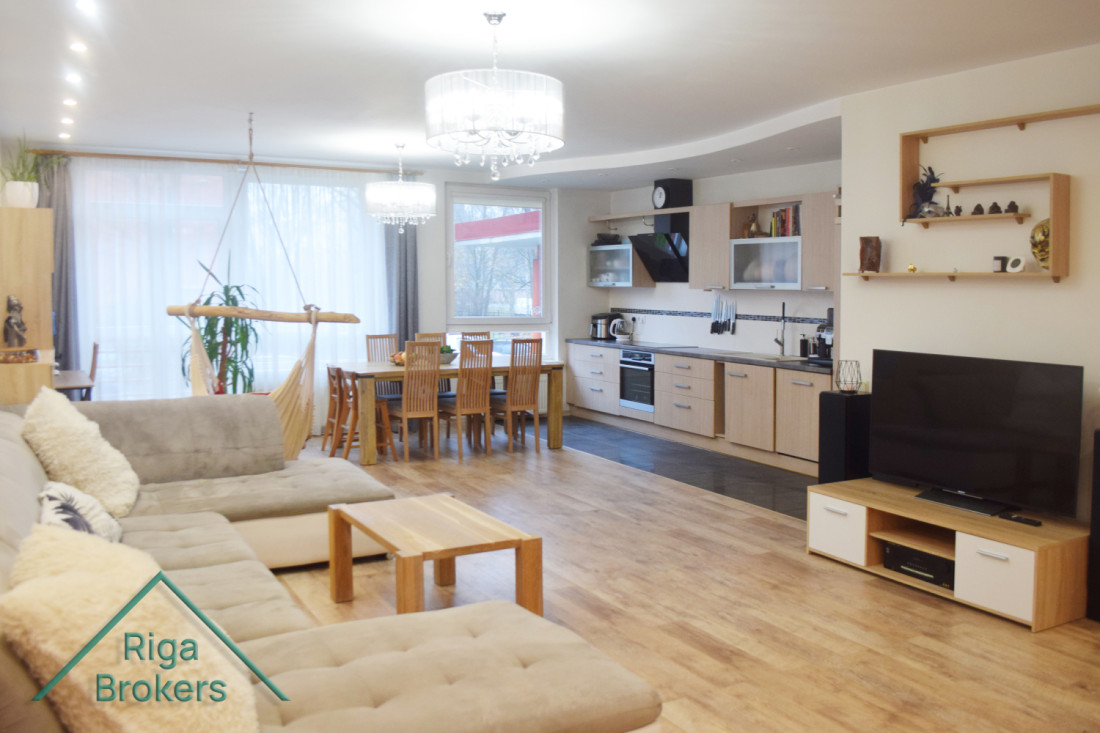Spacious living room with kitchen and dining area.
