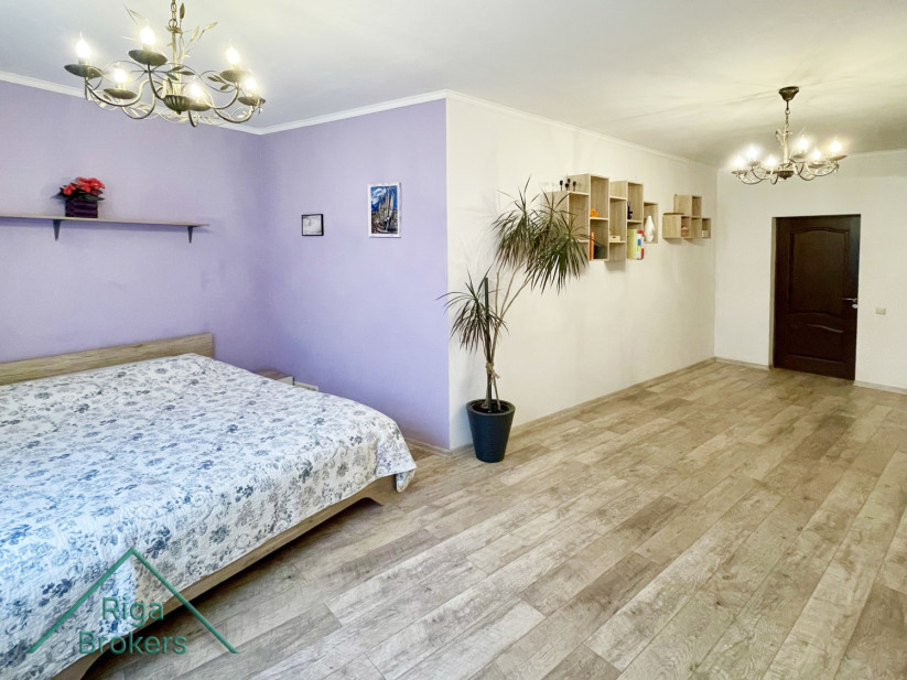 Bedroom with bed and purple wall.