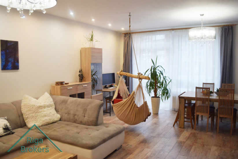 Living room with hammock and dining table.