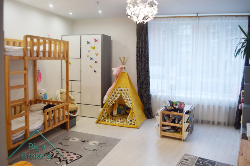 Children's room with wooden bed and play tent.