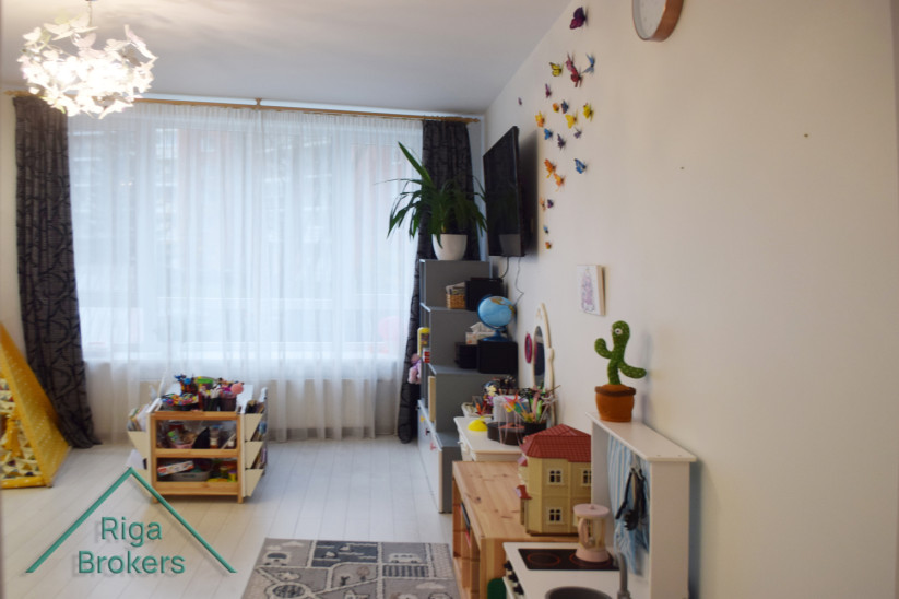 Children's room with toy shelves and window.
