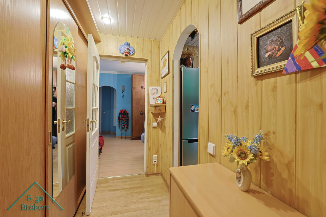 Hallway with wooden walls and decorations.