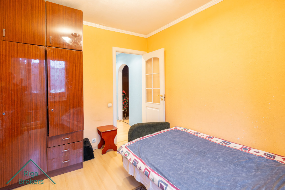 Bedroom with wardrobe and open doors.