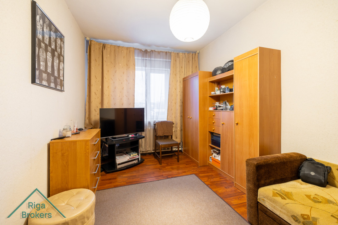 Room with wooden furniture and TV.