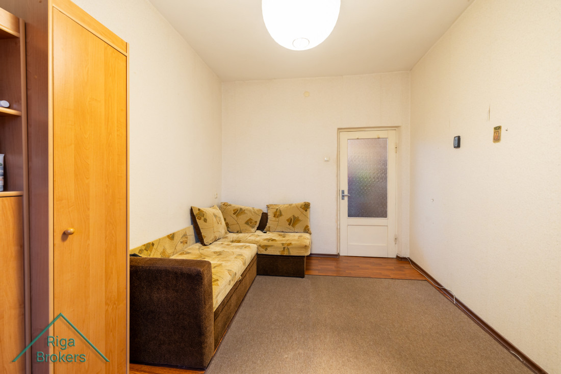 Room with sofa and door.