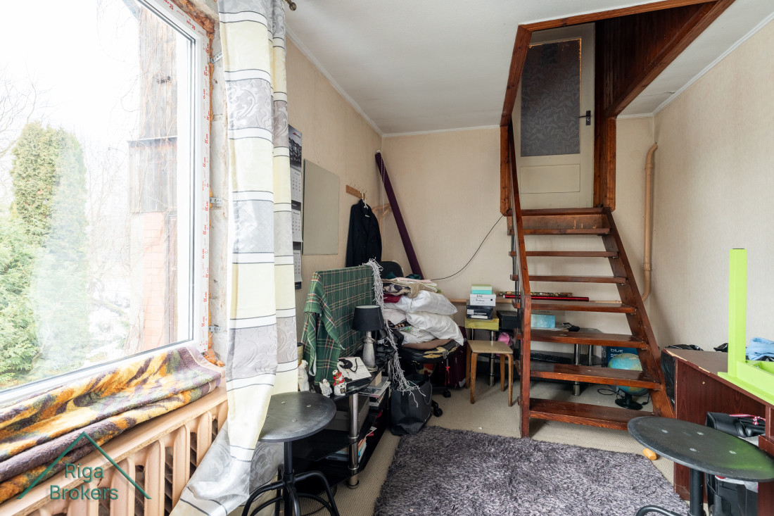 Room with stairs to the second floor.