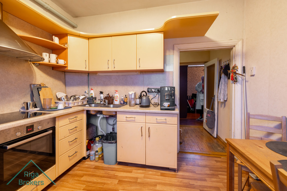 Kitchen with appliances and cabinets along the wall.