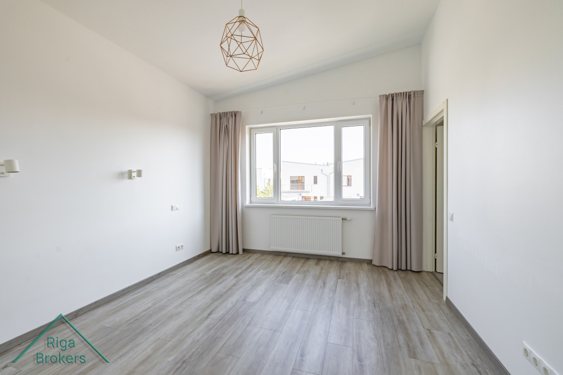 Spacious bedroom with a large window