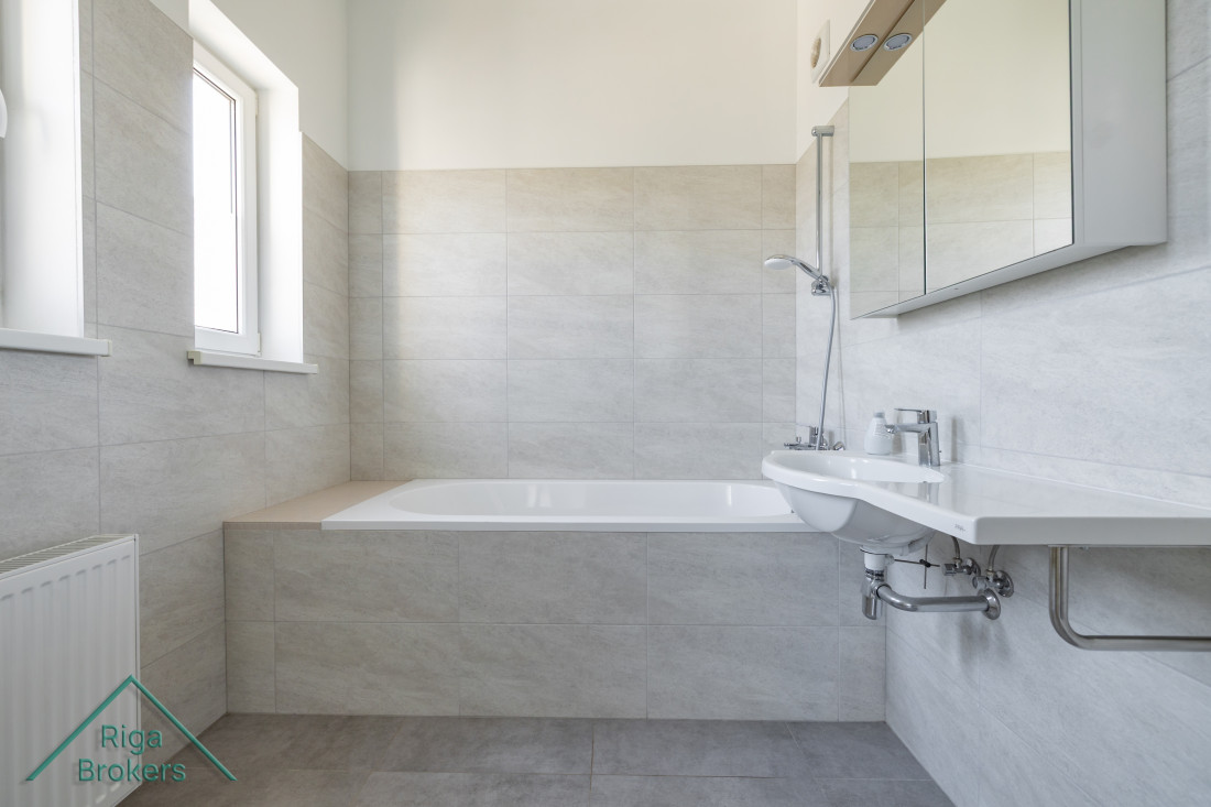 Bathroom with bathtub and window