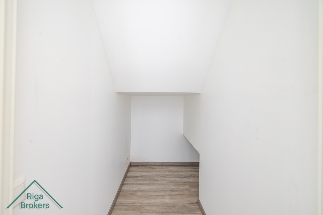 White storage space under the stairs