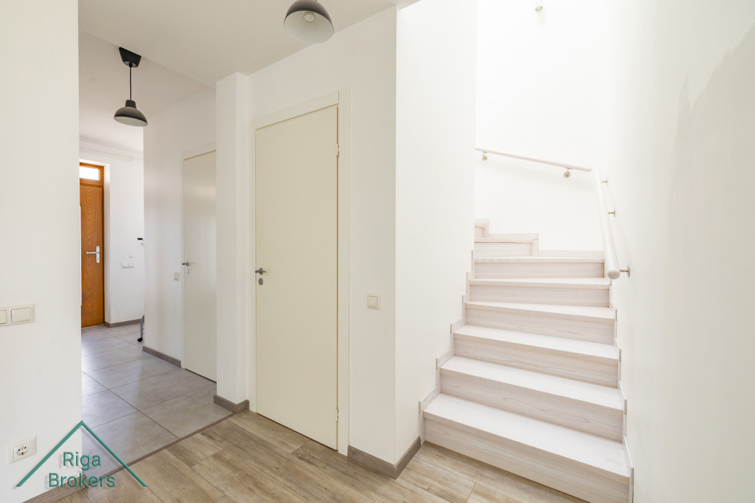Hallway with stairs to second floor