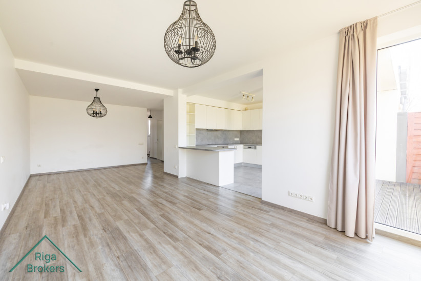 Spacious living room with kitchen area